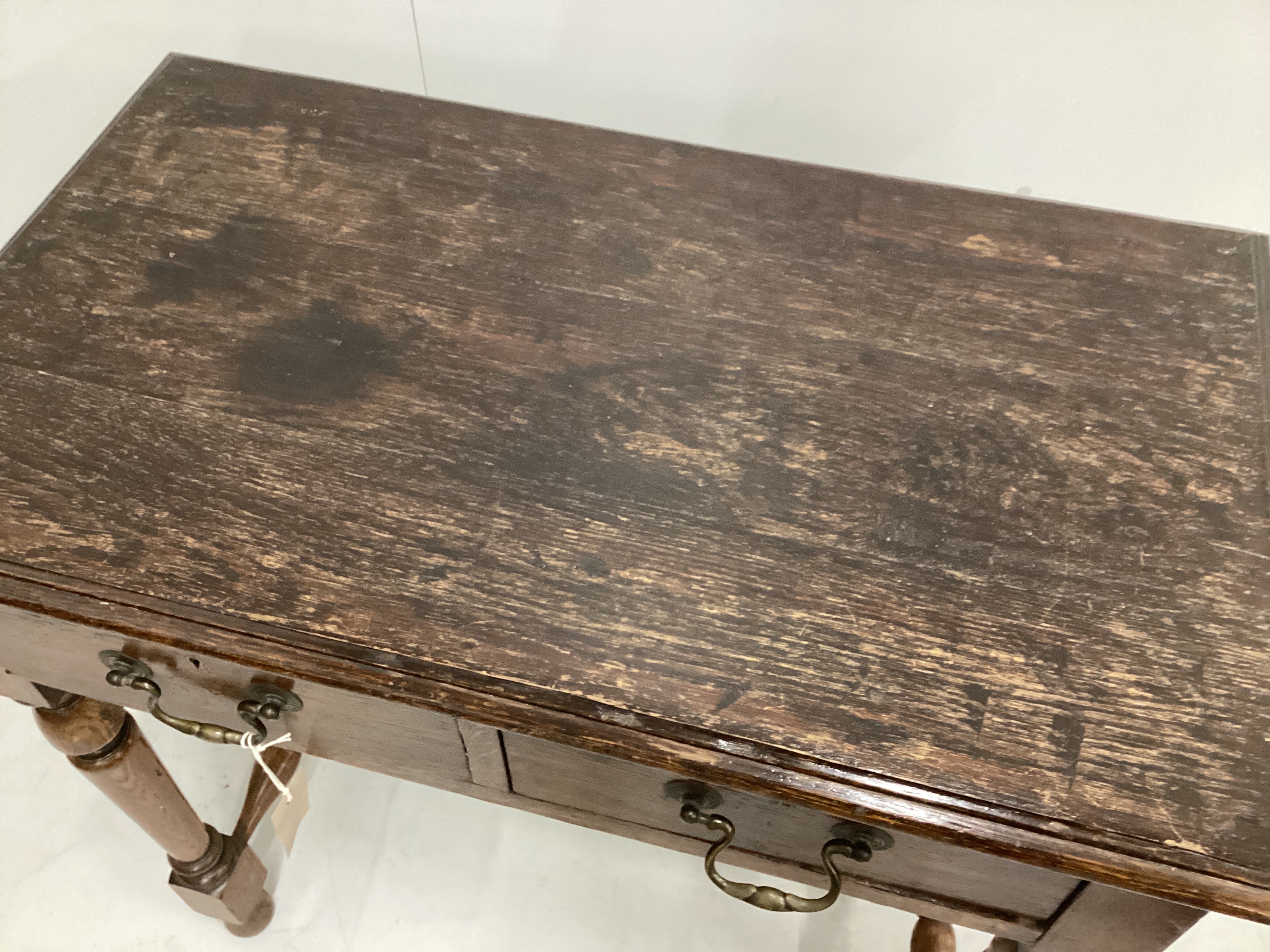 An early 20th century oak two drawer side table, width 76cm, depth 44cm, height 76cm